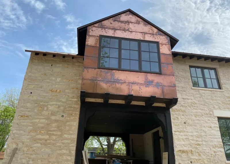Copper metal panel facade on a stone building for Skylight Installation in Cherry Valley