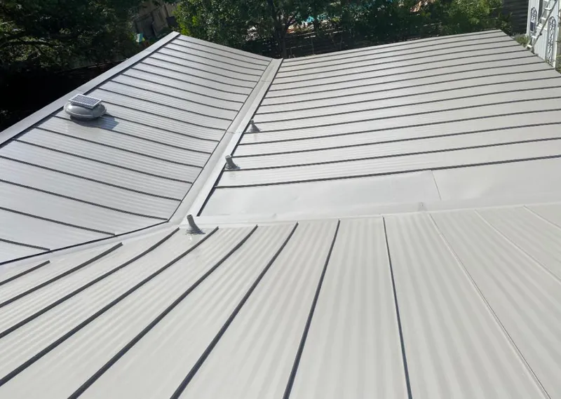 Solar attic fan installed on a metal roof for Roof Ventilation in Cherry Valley